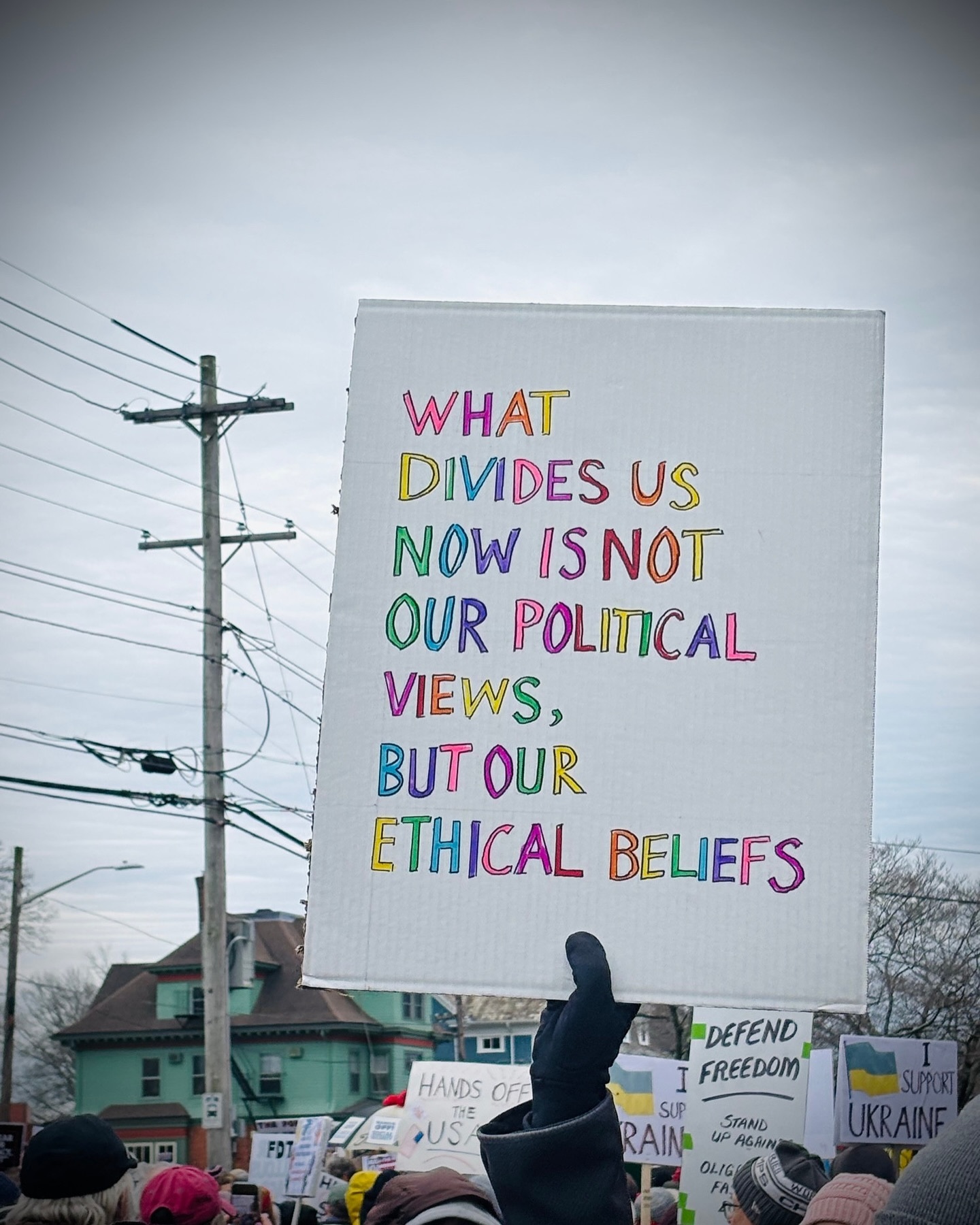 Hands off protest sign, what divides us is not our political views but our ethical beliefs, hands off meme